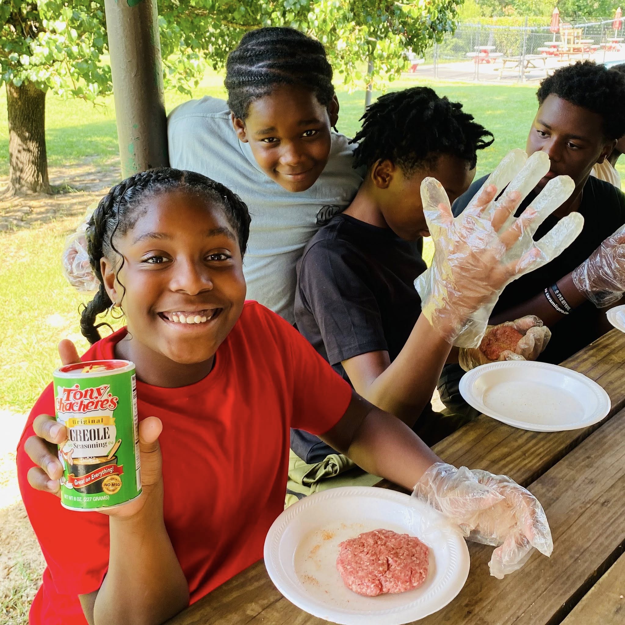 A girl holding a can of seasoning.